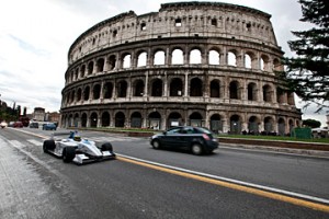 A Formula E car races along the streets of Rome